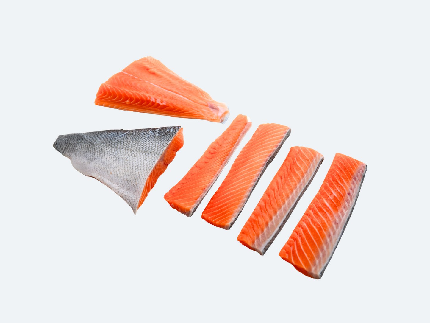 Several pieces of raw salmon, including both tail and center portions, isolated on a white background.