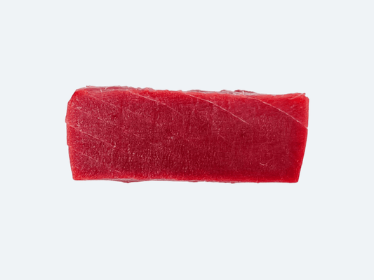 A single slice of fresh bluefin tuna akami on a white background.